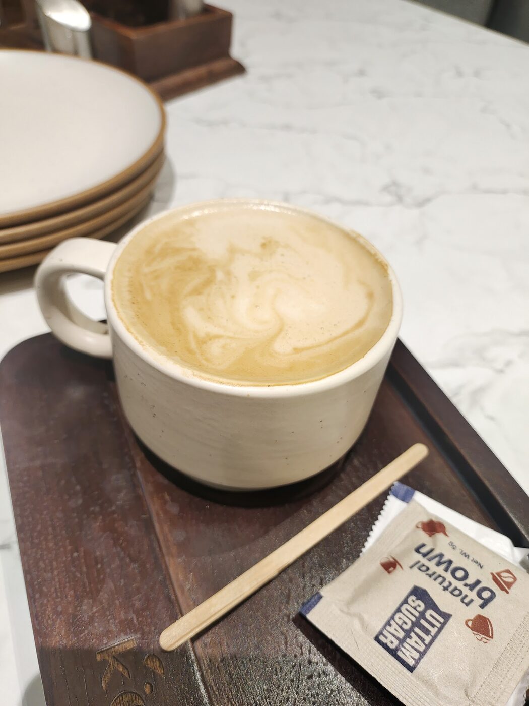 A latte on a wooden tray